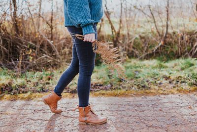 Low section of woman standing on land