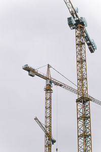 Low angle view of crane against clear sky