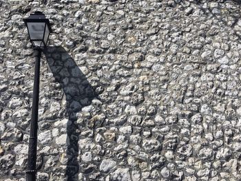 Gas light against stone wall