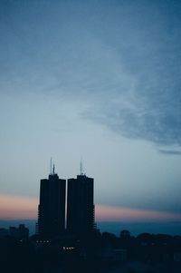 Illuminated cityscape against sky