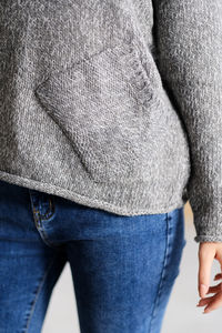 Fashionable gray wool sweater and blue jeans on a female body. concept of casual clothing.