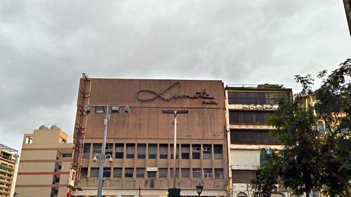 Low angle view of building against cloudy sky