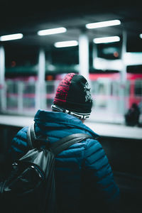 Rear view of woman standing in snow