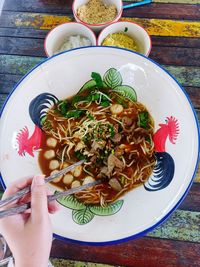 Cropped hand of woman having food