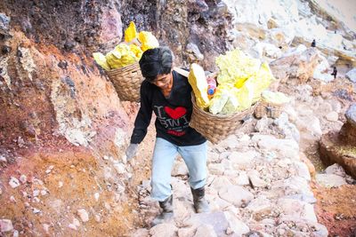 The struggle to break through the toxic smoke of sulfur miners at ijen crater