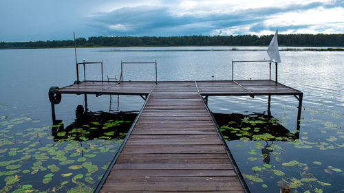 Pier over lake against sky