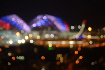 Defocused image of illuminated city at night