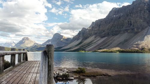 Calm lake with mountains in background