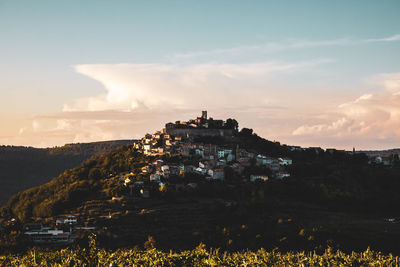 Panoramic view of buildings and mountains against sky