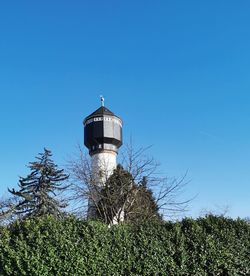 Low angle view of lighthouse against clear blue sky