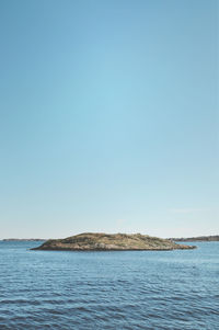 Scenic view of calm sea against clear sky