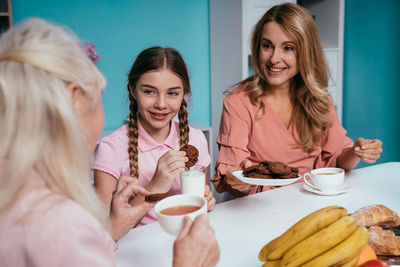 Cheerful family enjoying breakfast at home