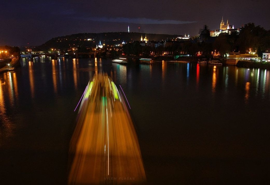 illuminated, water, night, city, reflection, building exterior, architecture, sky, built structure, no people, nature, river, transportation, nautical vessel, outdoors, waterfront, building, motion, lighting equipment, cityscape