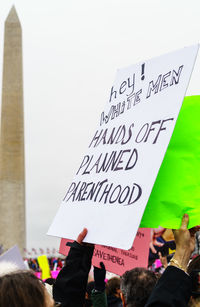 People with text on placard in city during protest