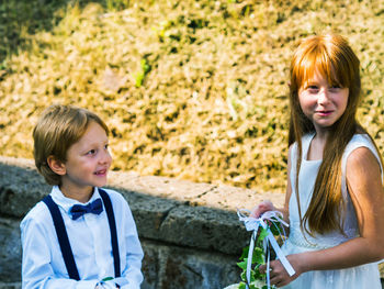 Smiling boy and girl during wedding ceremony