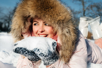 Portrait of a smiling young woman in snow