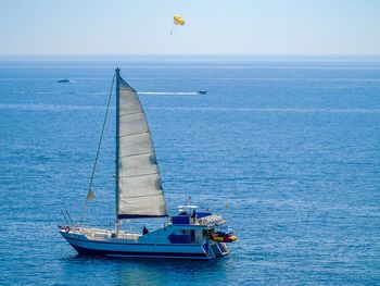 Sailboat sailing on sea against sky