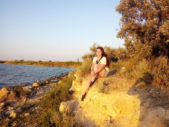 Rear view of woman standing at beach