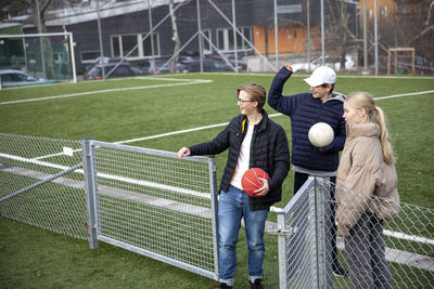 Friends standing on school soccer field