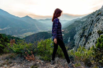 Full length of man standing on mountain against sky