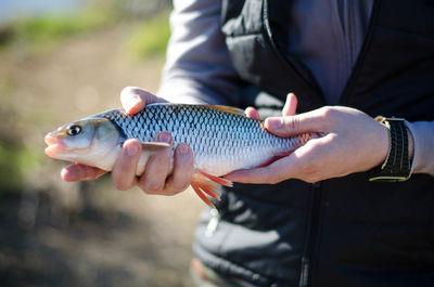 Cropped image of woman holding cigarette