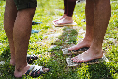 Low section of man standing on ground in park