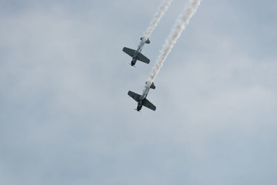 Low angle view of airplane flying against sky