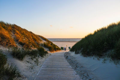 Scenic view of sea against clear sky during sunset