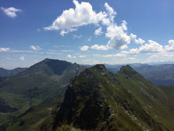 Scenic view of mountains against cloudy sky