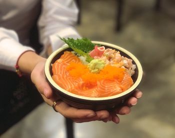 Midsection of man holding bowl