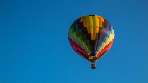 Low angle view of hot air balloon against blue sky