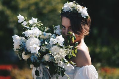 Close-up of woman with white roses