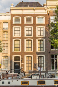 Residential building by street against sky