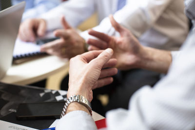 Midsection of business people discussing in office