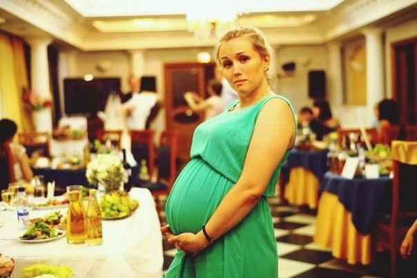 indoors, lifestyles, casual clothing, person, food and drink, leisure activity, sitting, young adult, table, restaurant, front view, waist up, looking at camera, portrait, food, three quarter length, holding, smiling