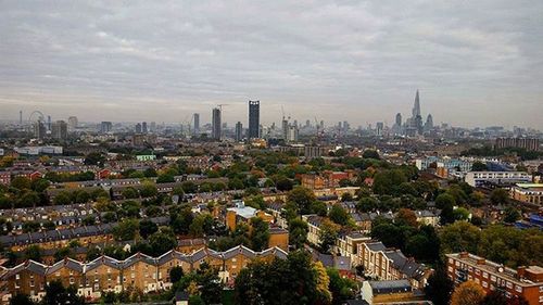 Cityscape against cloudy sky