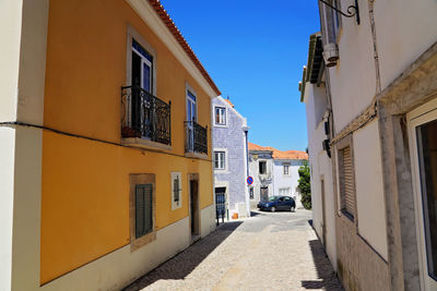 Empty alley amidst buildings in city