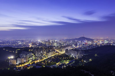 High angle view of illuminated city buildings at night