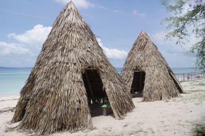 Built structure on beach against sky