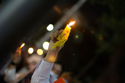 Person holding lit candles
