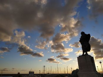 Low angle view of statue against sky during sunset