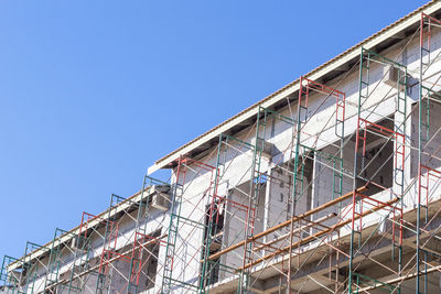 Low angle view of building against clear blue sky