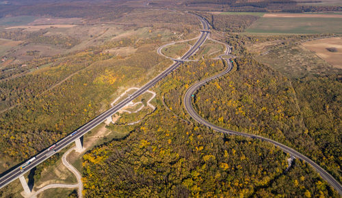 High angle view of winding road on landscape during autumn