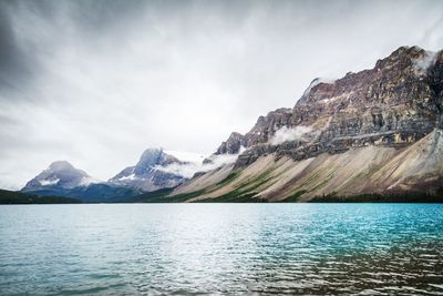 Scenic view of bow lake by mountains against sky