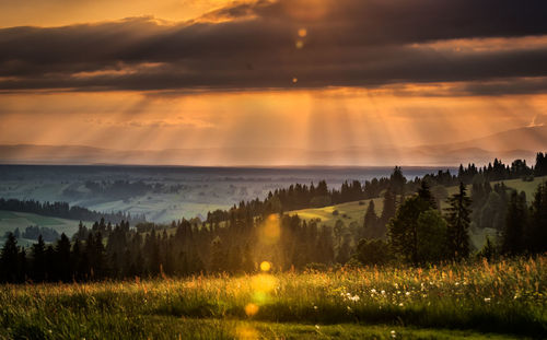 Scenic view of landscape against sky at sunset