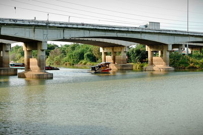 Arch bridge over river against sky