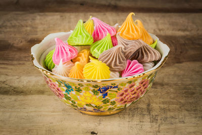 Close-up of multi colored candies in bowl on table