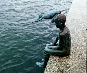 Close-up of statue against water