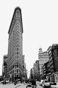 View of city street and buildings against sky