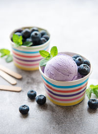 Homemade blueberry ice cream with fresh blueberries. sweet berry summer dessert. concrete background